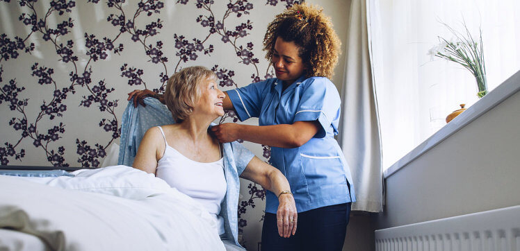caregiver assisting elder woman