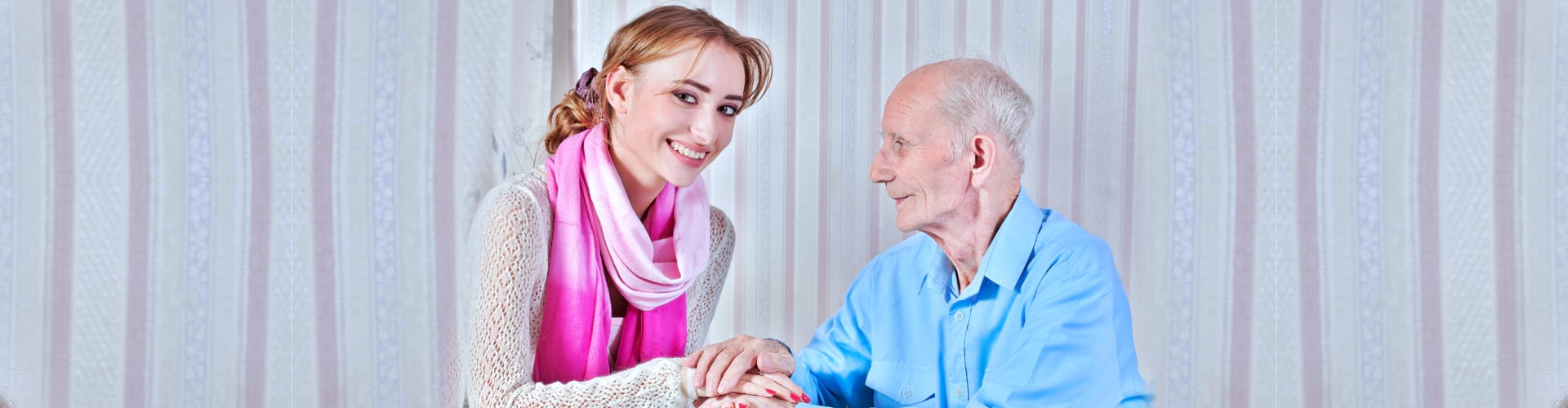 Senior men with her caregiver at home close-up